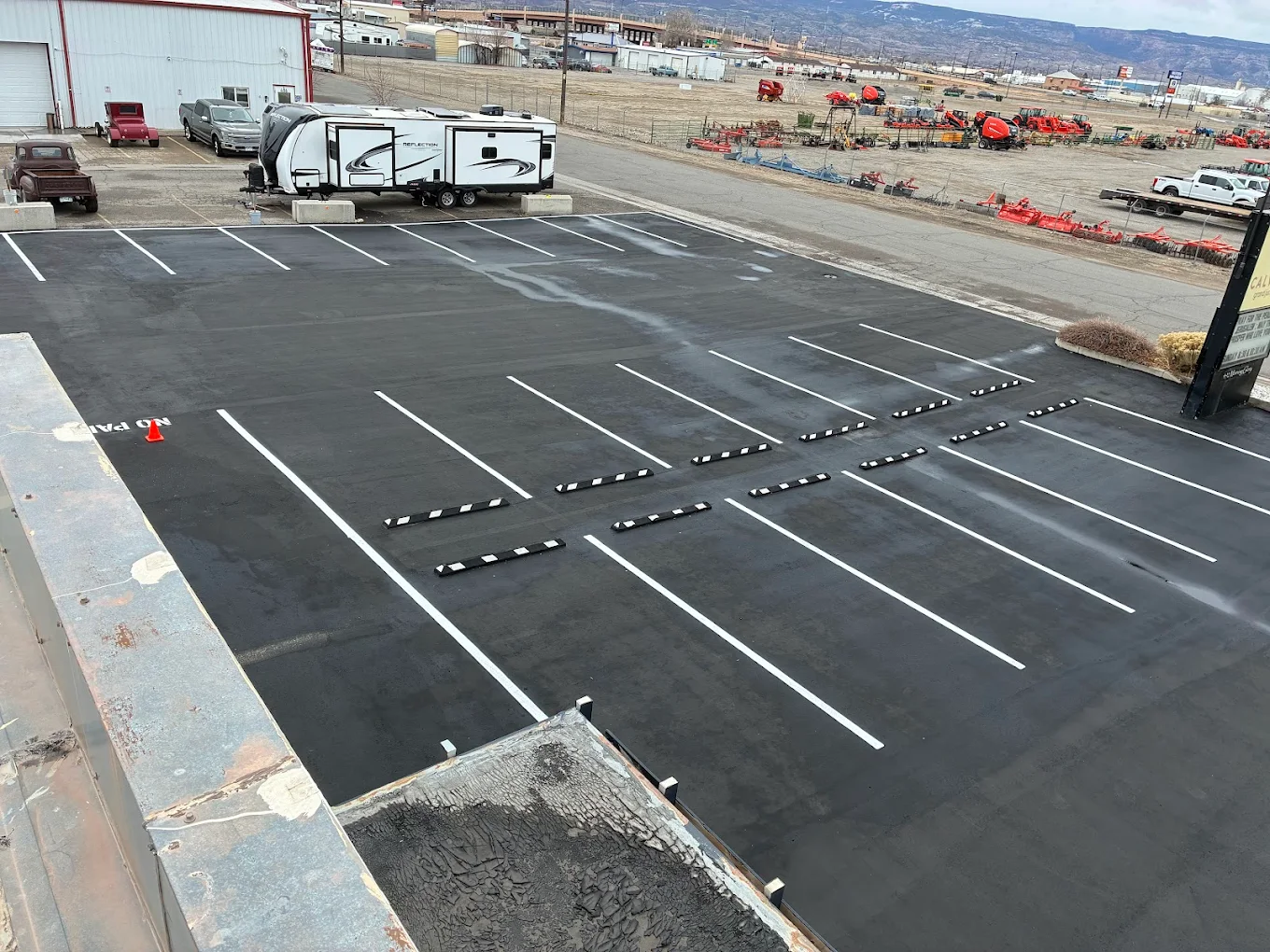 Aerial view of a freshly striped commercial parking lot paved by D&M