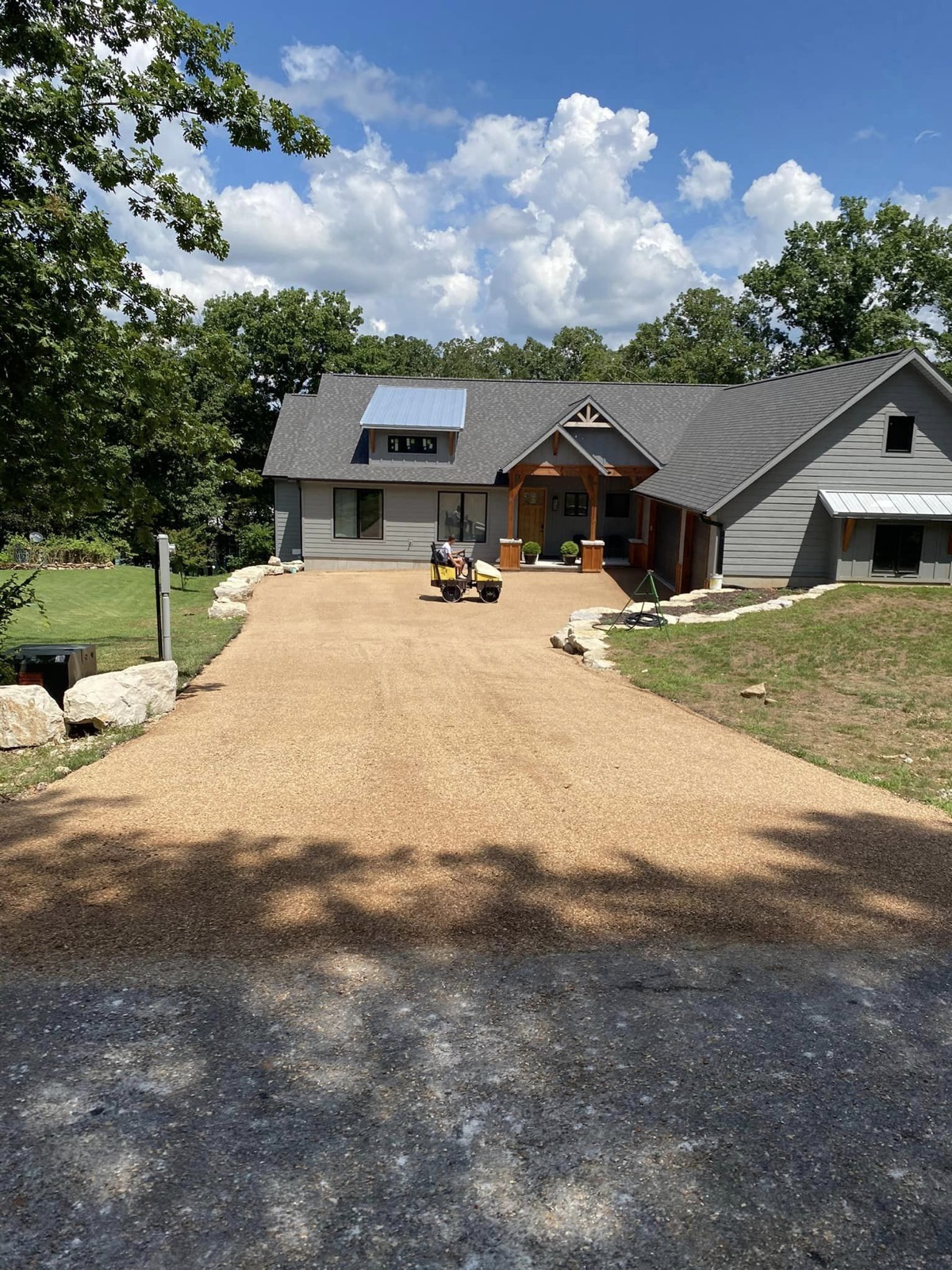 Modern home with a freshly paved asphalt driveway